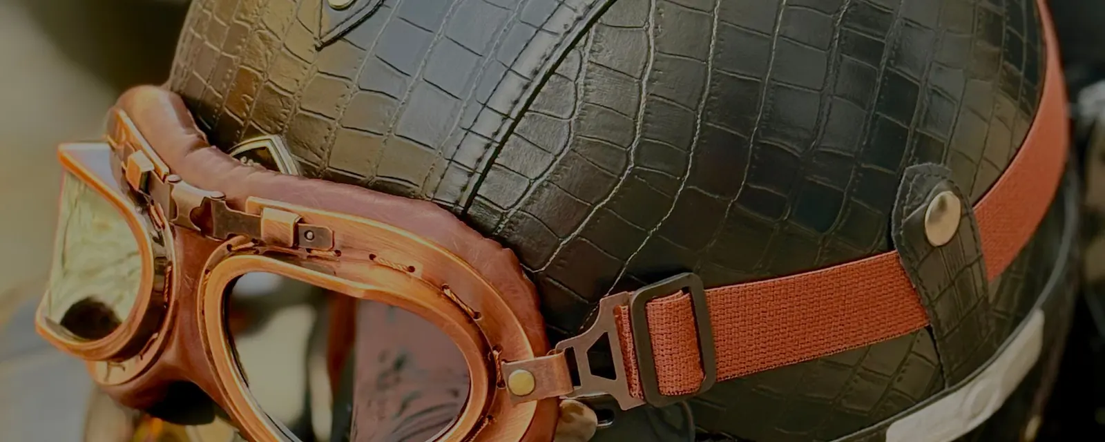 A leather helmet with amber-lensed goggles resting on top