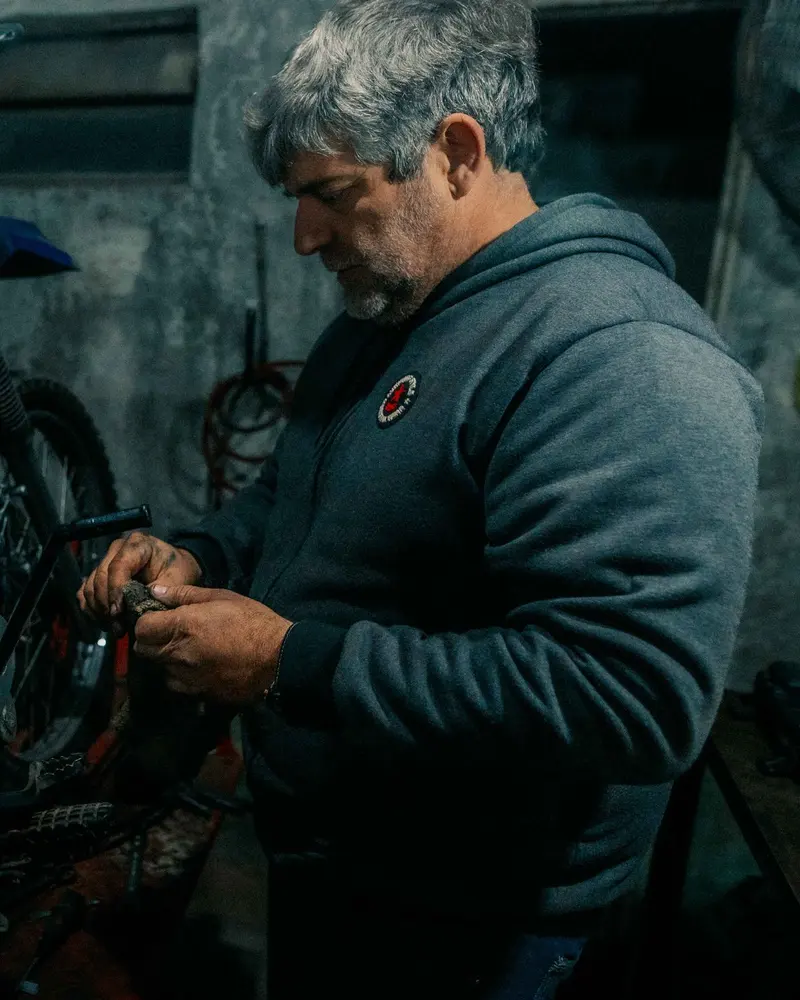 A mechanic works on a motorbike engine at the bench